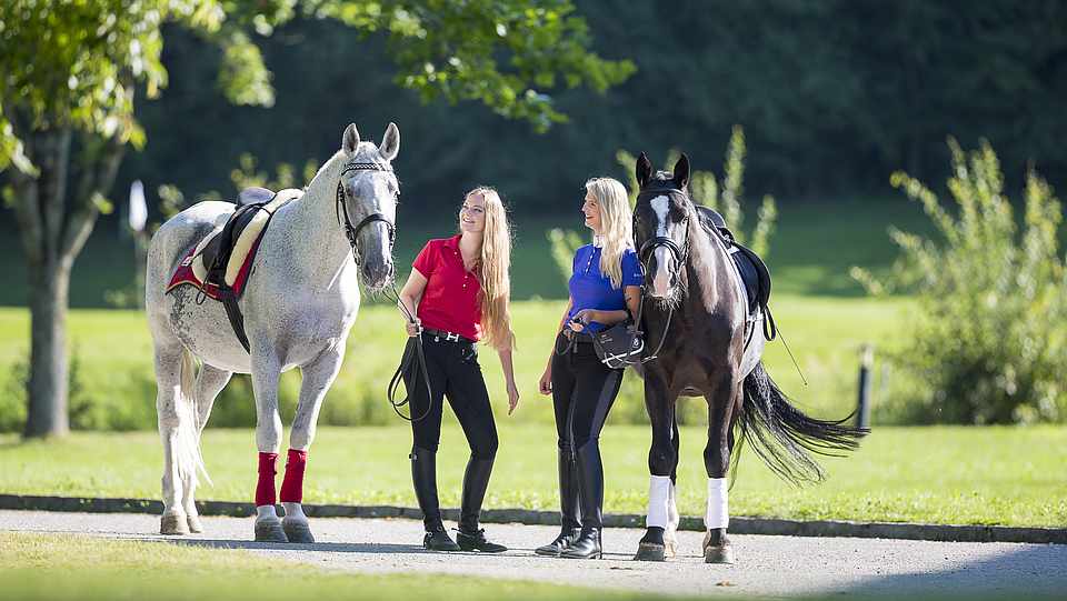 Zwei Frauen mit zwei Pferden